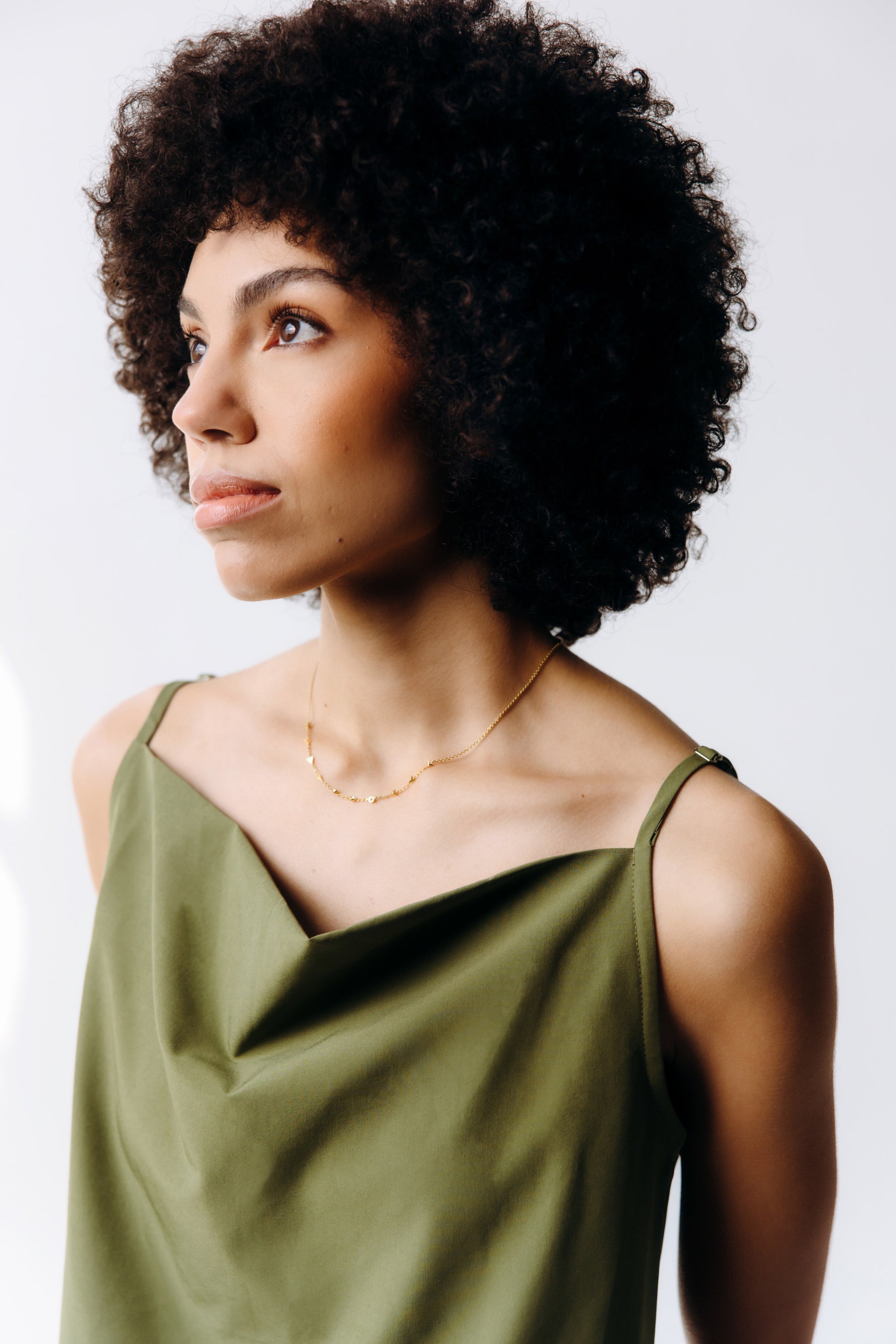 Woman wearing a green dress against a plain background