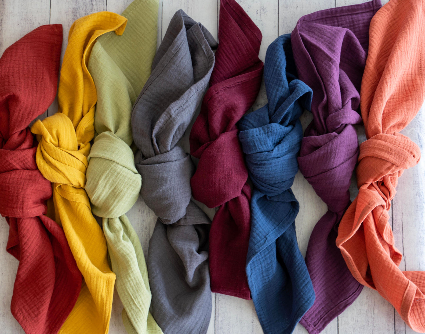 Colorful knotted fabric swatches on a wooden surface