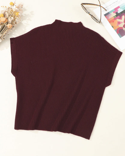Brown ribbed sleeveless sweater on a white surface with decorative elements.
