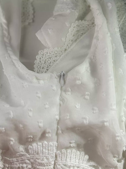 Close-up of a white lace garment with intricate detailing.