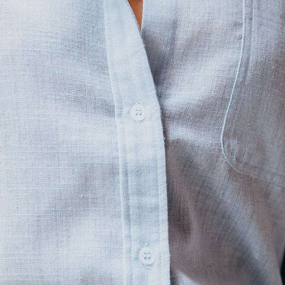 Close-up of a light blue textured shirt with buttons