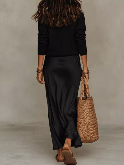 Back view of black ribbed top and satin midi skirt set.