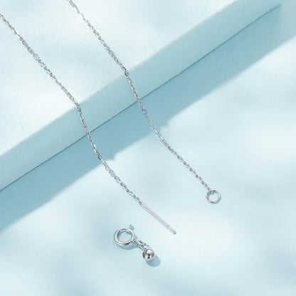 Silver necklace with a small pendant on a light blue background