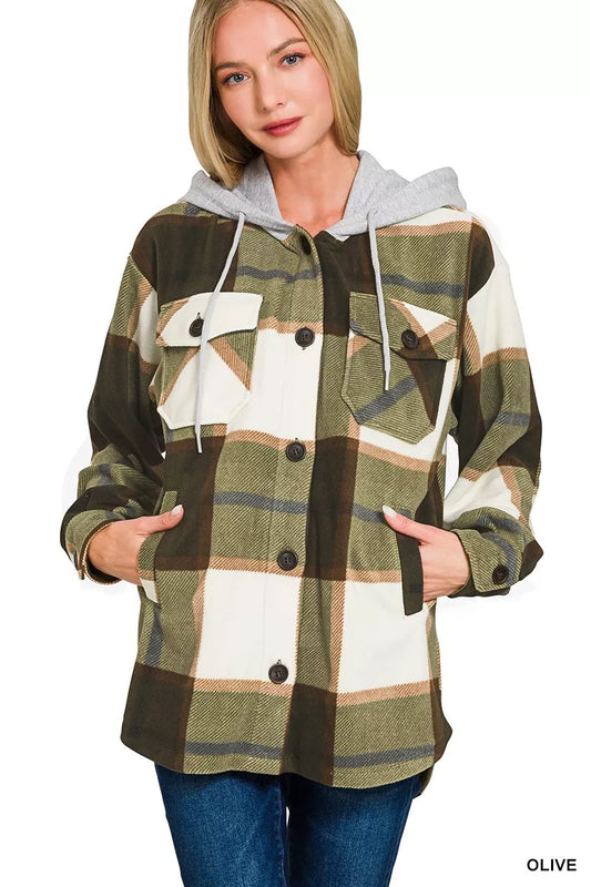 Woman wearing a plaid jacket with a hood on a white background