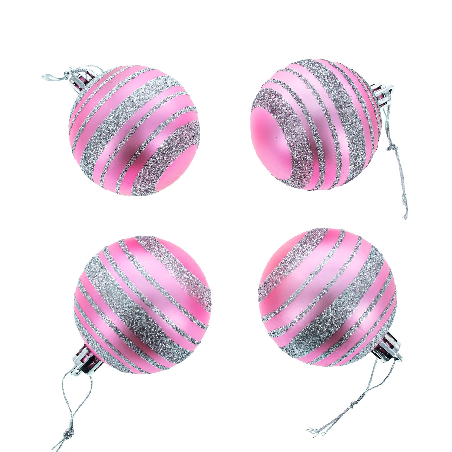 Four pink plastic ball ornaments with silver glitter stripes and hanging strings arranged in a square on a white background.