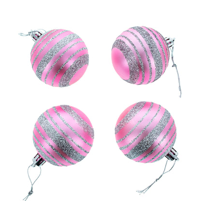 Four pink plastic ball ornaments with silver glitter stripes and hanging strings arranged in a square on a white background.