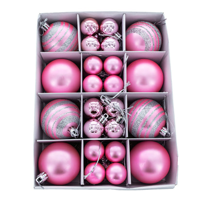 Forty pink plastic ball ornaments in matte, shiny, and silver glitter striped finishes arranged in a white grid box.