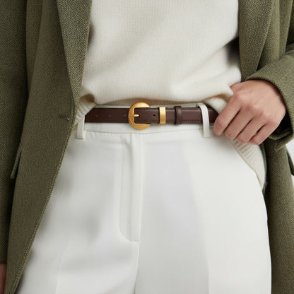 Person wearing a green coat, white shirt, and white pants with a brown belt.