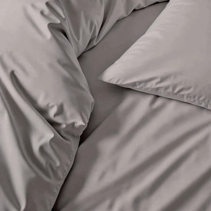 Gray bedding set with pillows on a bed