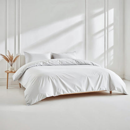 White bedding set on a bed in a bright room with minimal decor