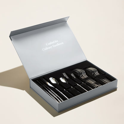 Set of silver cutlery in an open box with 'Luxury without labels' text on a light background