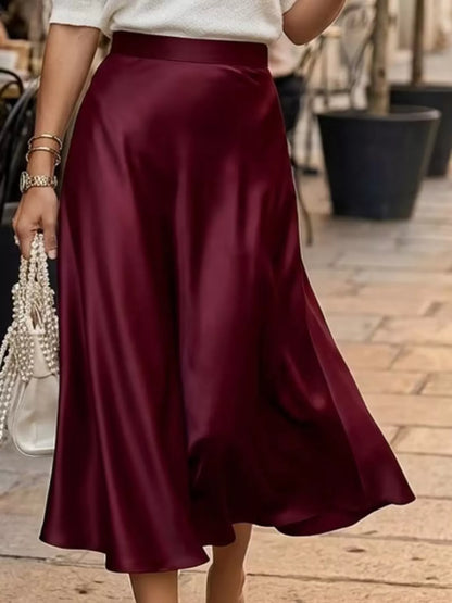 Person wearing a burgundy skirt with a blurred background