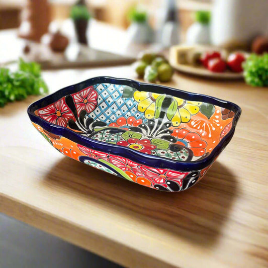 Colorful ceramic dish with floral patterns on a wooden surface