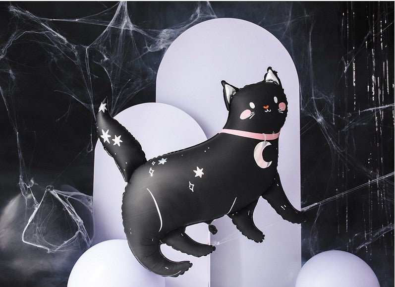 Black cat-shaped inflatable toy with star and moon designs on a dark background with spider webs.