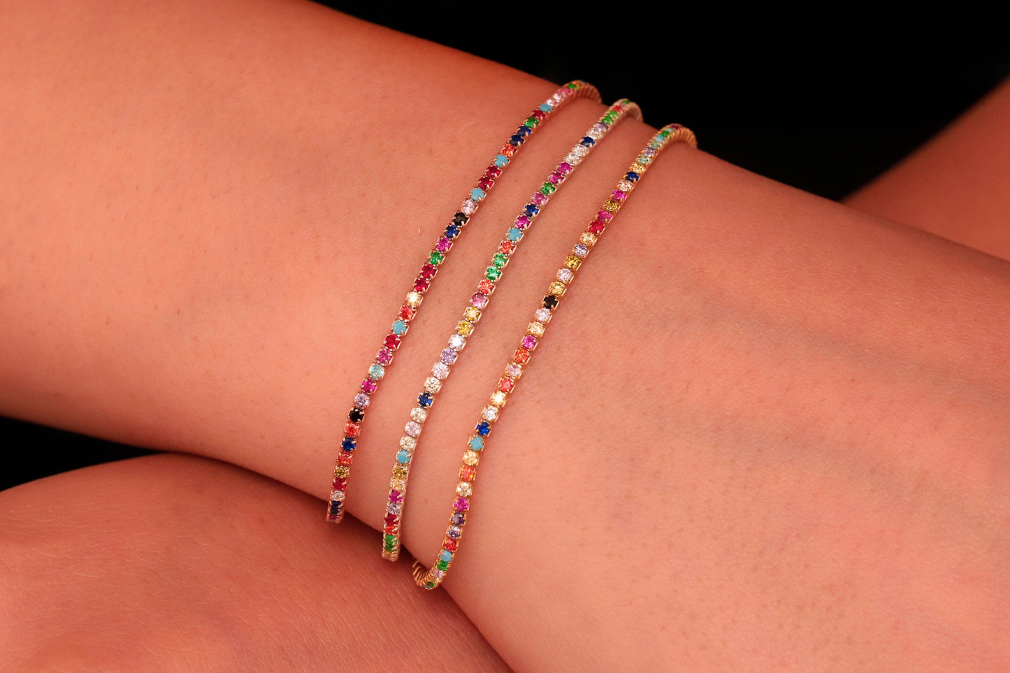 Colorful Dreams rainbow bracelet featuring multiple strands with vibrant gemstones on a gold-tone band.