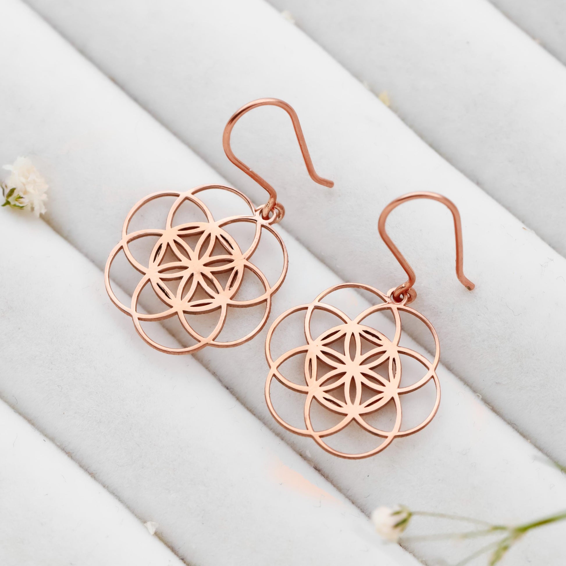 Dangle sacred geometry earrings in 925 sterling silver with intricate floral design and a rose gold finish.