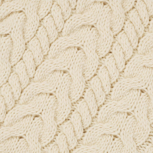 Close-up of a textured beige fabric with a cable knit pattern