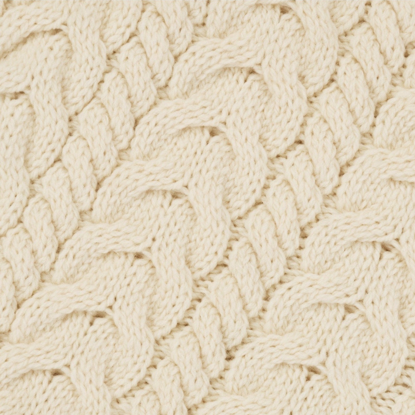Close-up of a textured beige fabric with a cable knit pattern