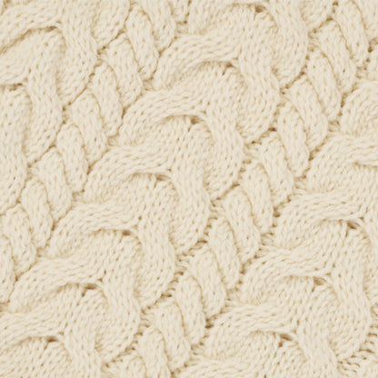 Close-up of a textured beige fabric with a cable knit pattern