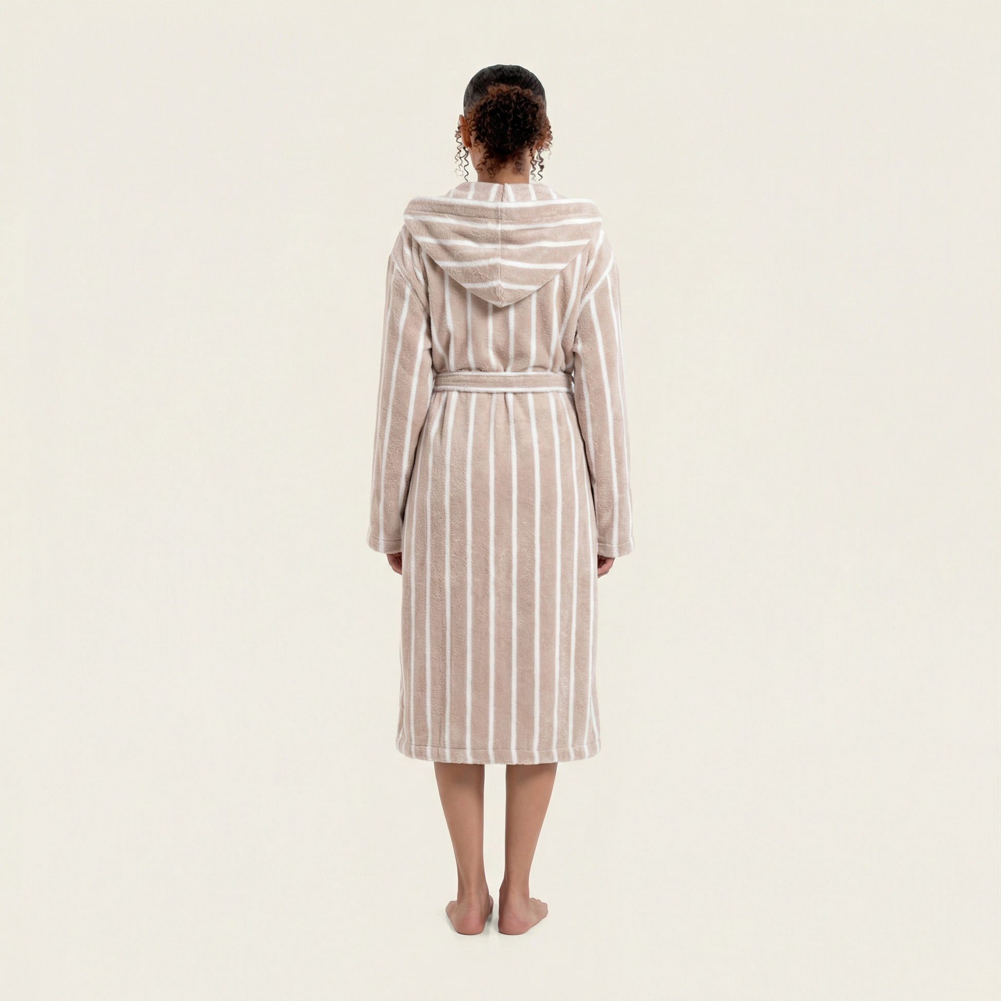 Person wearing a striped robe on a plain background