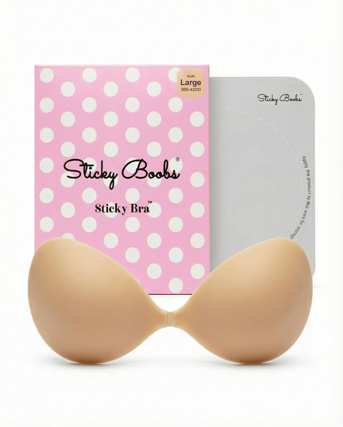 Beige Sticky Boobs adhesive bra in Large with pink polka-dot packaging and protective storage board.