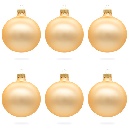 Six rose gold glass ball ornaments with a matte finish arranged in two rows of three on a white background.