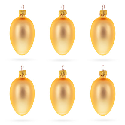 Six rose gold glass egg ornaments with metallic caps arranged in two rows on a white background.