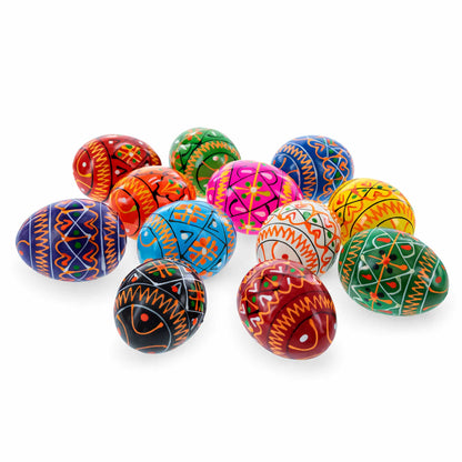 Twelve colorful wooden eggs with geometric Ukrainian Pysanky patterns arranged in a cluster on a white background.