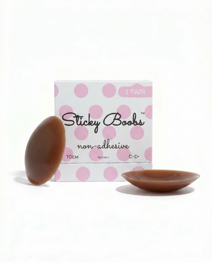 Dark non-adhesive silicone nipple covers with Sticky Boobs packaging labeled C–D+, 10 cm.
