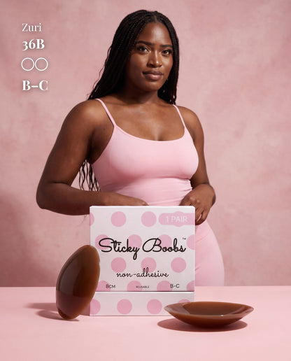 Model in a pink camisole behind Dark nipple covers and B–C packaging, with a 36B size label.