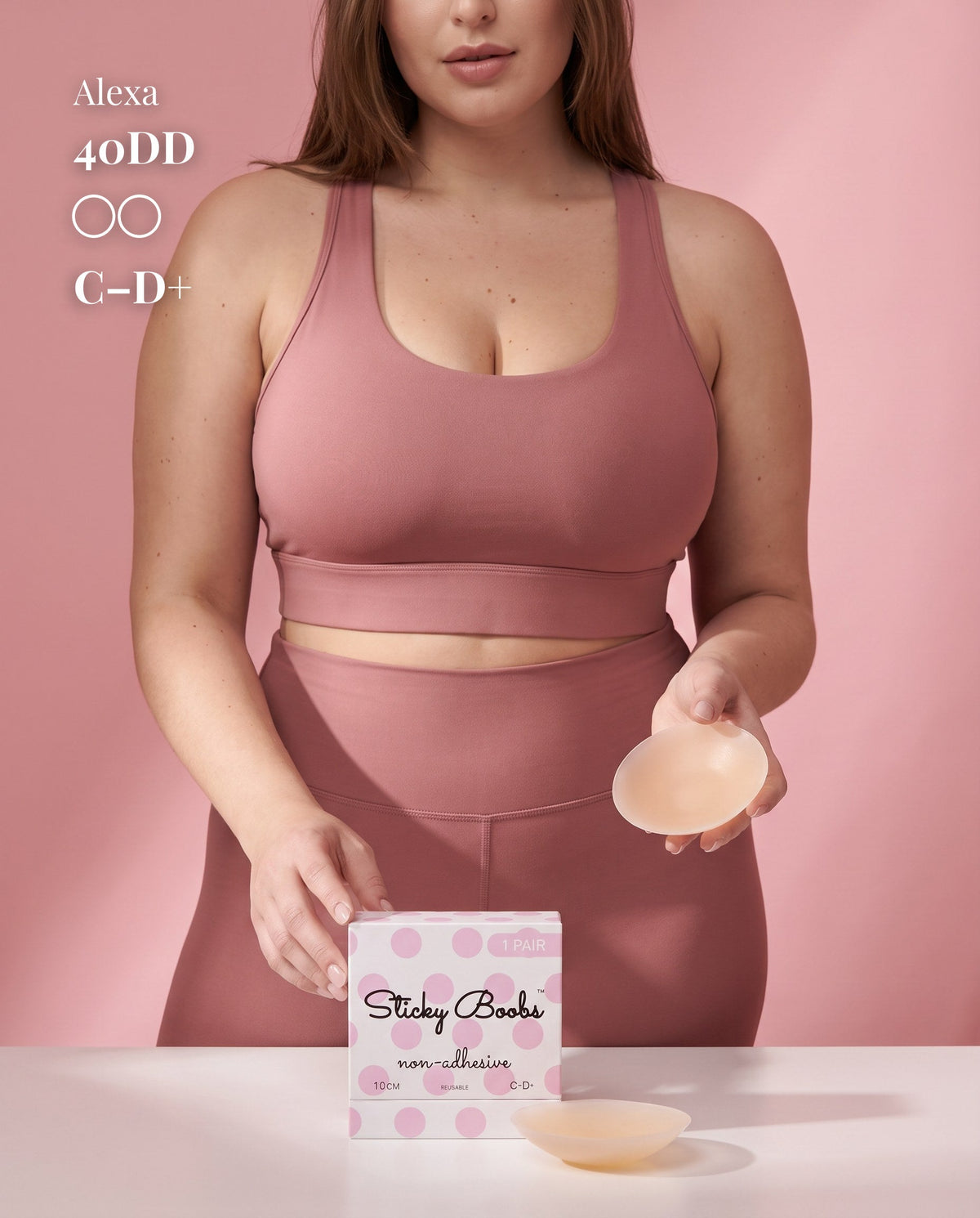 Model in pink activewear holding a Light nipple cover beside C–D+ packaging, labeled 40DD.