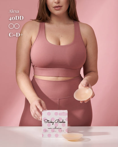 Model in pink activewear holding a Light nipple cover beside C–D+ packaging, labeled 40DD.