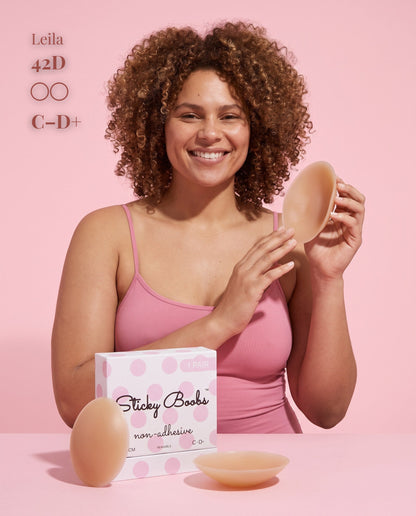 Model in a pink camisole holding a Tan nipple cover beside C–D+ packaging, labeled 42D.