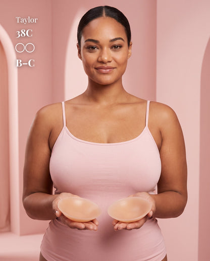 Model in a pink camisole holding two Tan nipple covers, with labels showing 38C and B–C.