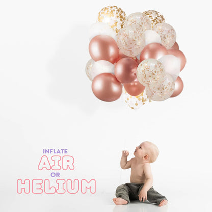 Dandy Decor 60 pack of 12-inch rose gold and white confetti balloons, with a child sitting beside them.