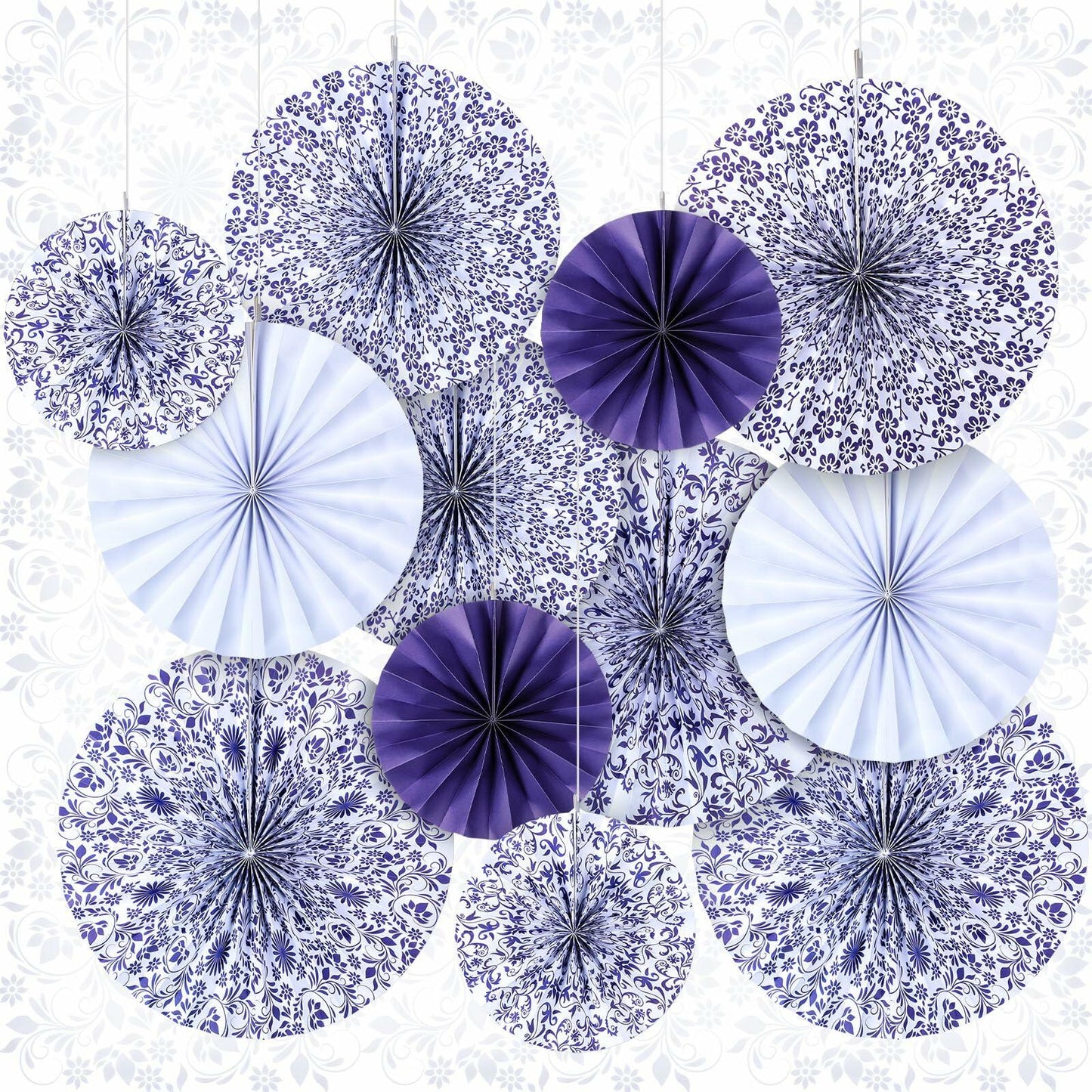 Chinoiserie hanging paper fans in blue and white, featuring floral and geometric patterns, arranged in a decorative display.