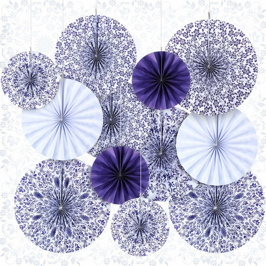 Chinoiserie hanging paper fans in blue and white, featuring floral and geometric patterns, arranged in a decorative display.