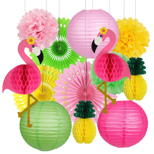 Flamingo pineapple party decorations featuring pink and green paper lanterns, pom poms, and honeycomb shapes.