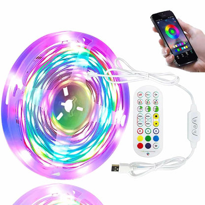 Coiled RGB LED strip light glowing in multi-color purple and blue with a white USB remote and smartphone app control.