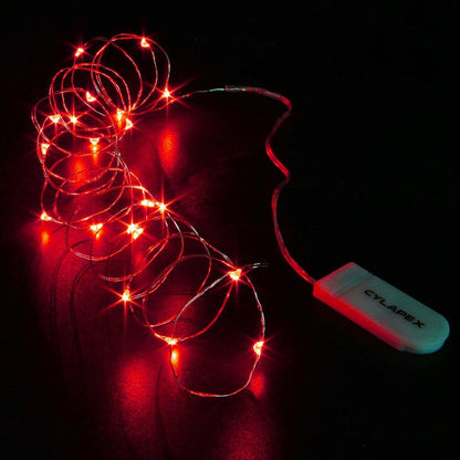 Red LED string lights coiled on a dark surface with a USB power adapter.