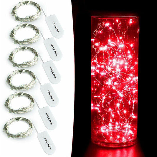 Set of string lights with packaging and a lit string light in a glass container.