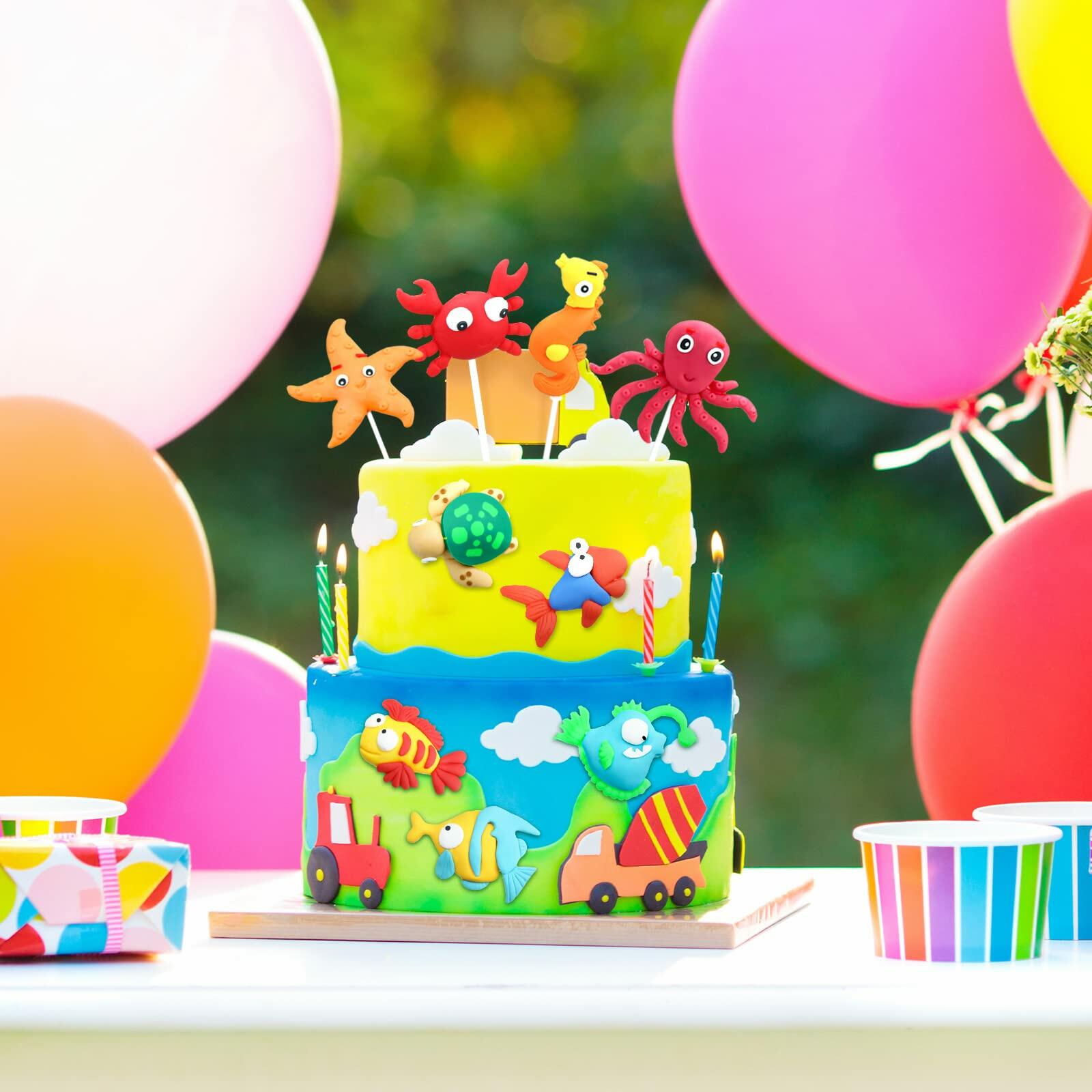 Colorful dinosaur cake toppers in various designs, each 2-3 inches, displayed on a vibrant cake with balloons.