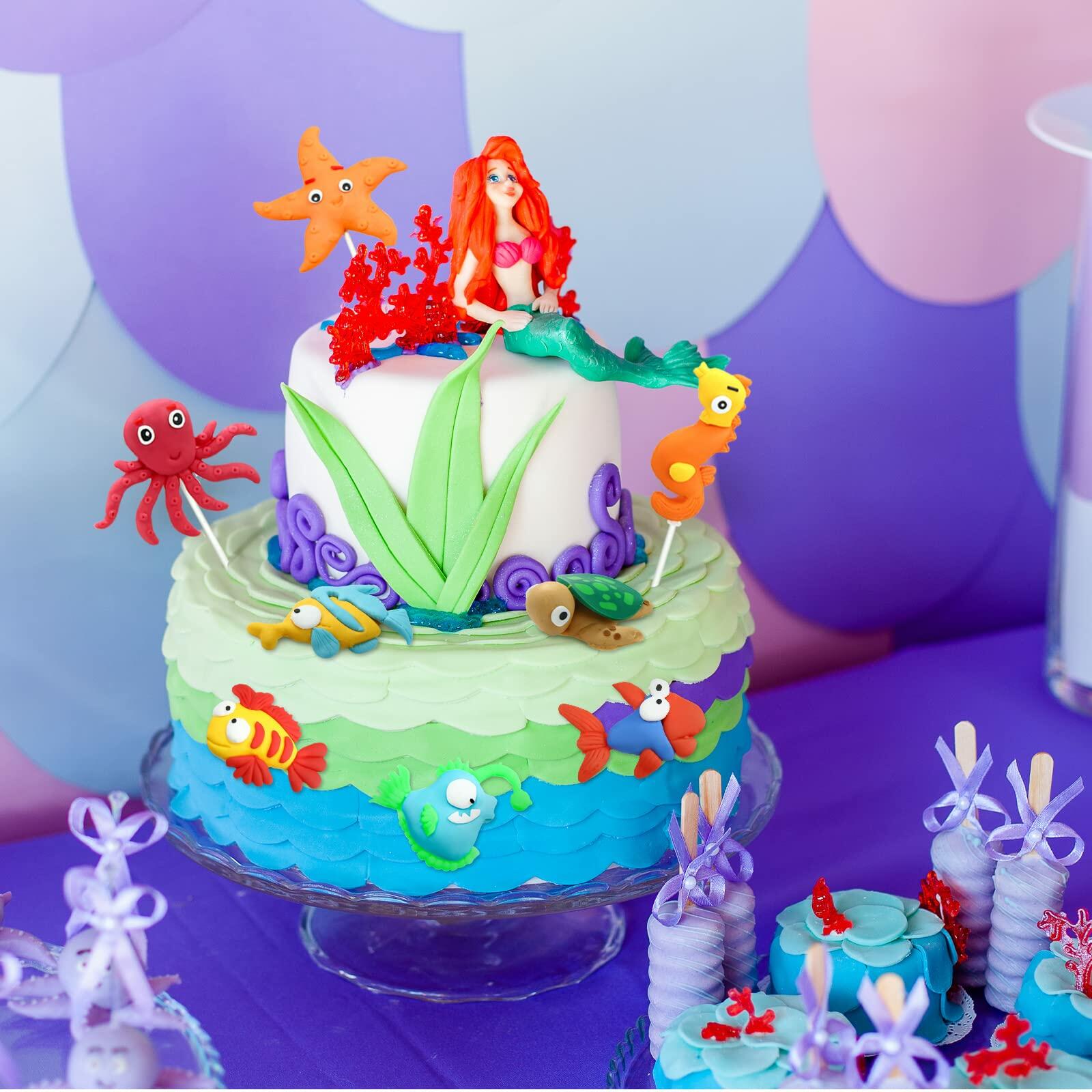 Colorful dinosaur cake toppers in various poses, each 2-3 inches, arranged on a light background for jungle safari theme.