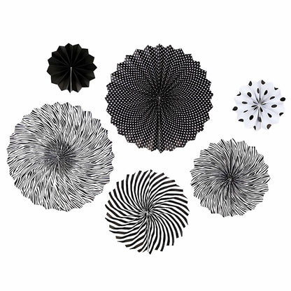 Black hanging paper fans in various designs, including stripes and polka dots, arranged in a circular pattern.
