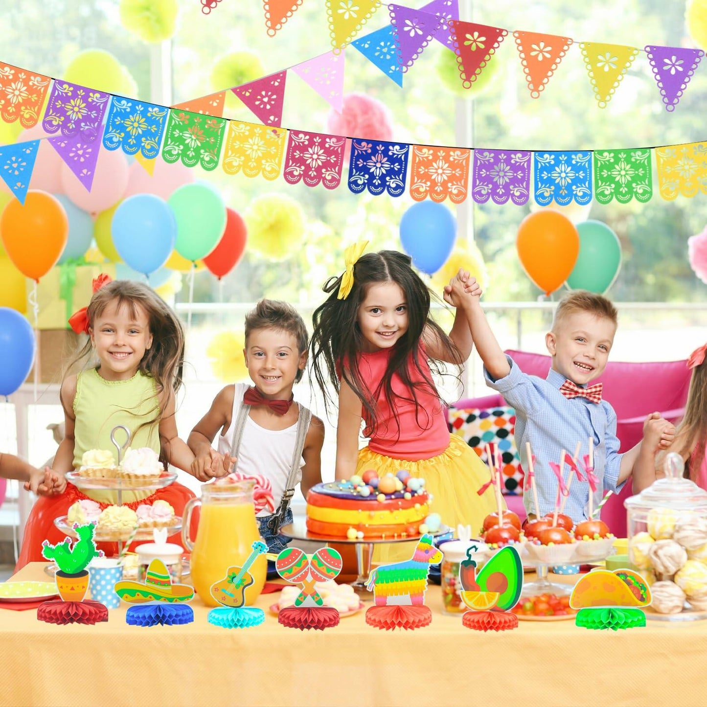 Colorful fiesta decorations for Cinco de Mayo, featuring a vibrant table setup with balloons, desserts, and themed centerp...