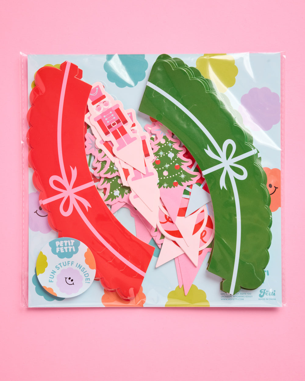 Set of colorful paper cutouts with decorative elements on a pink background