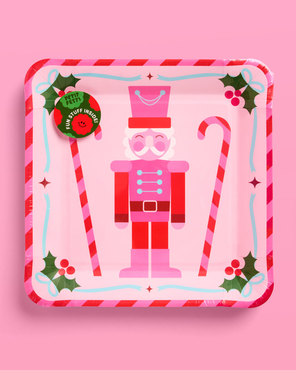 Decorative tin with a nutcracker design on a pink background