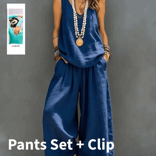 Person wearing a blue pants set with a clip on a gray background