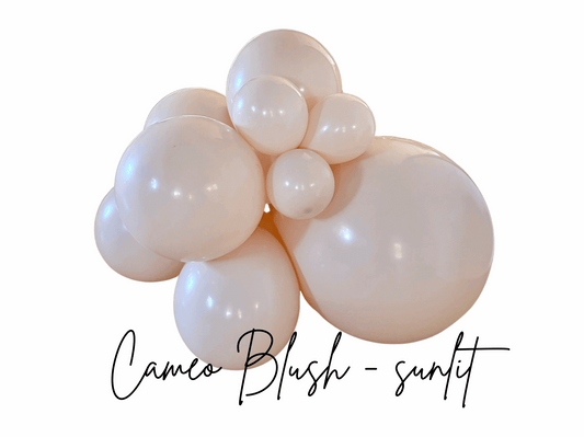 Cluster of pink balloons with 'Cameo Blush - sunlit' text on a white background