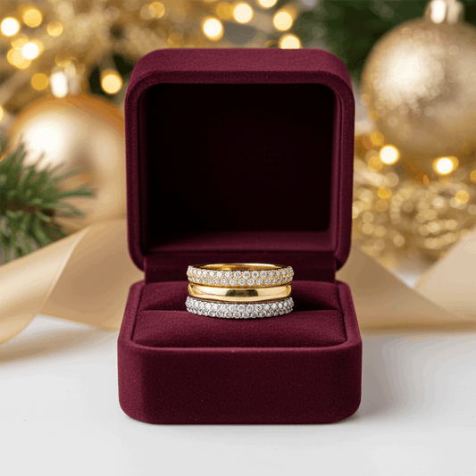 Gold ring with diamond accents on a velvet jewelry box.